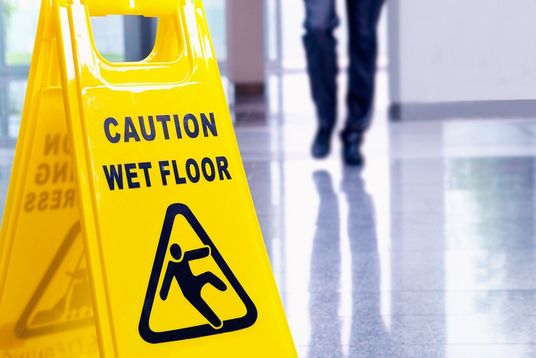 Close up of a wet floor caution sign in a hallway
